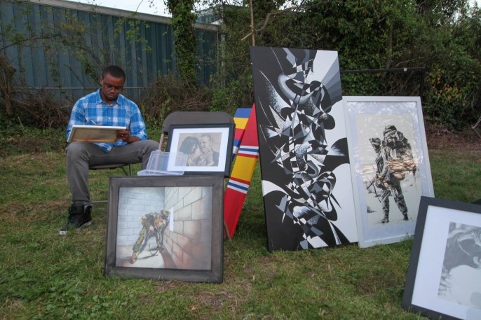 Original paintings displayed at an outdoor artist booth
