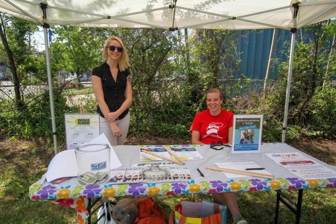 An artist displaying original work at an outdoor marketplace