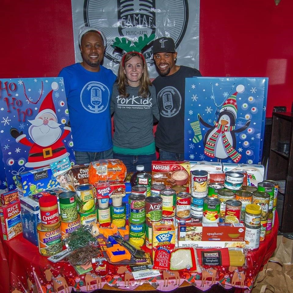 Volunteers with toys and canned food collected at the Jingle Jamboree drive benefiting ForKids